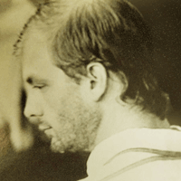 Yellowed photo of Jeffrey Dahmer, looking away from the camera.